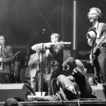 St. Paul and the Broken Bones frontman Paul Janeway, center, lies down on stage as bassist Jesse Phillips, right, looks on at the Sloss Music & Arts Festival in Birmingham, Ala., on Sunday, July 19, 2015. (MTSU Sidelines / John Connor Coulston)