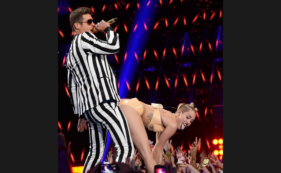 Robin Thicke, left, gets twerked on by Miley Cyrus, right, during a performance of "Blurred Lines" the 2013 Video Music Awards in Brooklyn, New York on Sunday, August 25, 2013. (FILE)