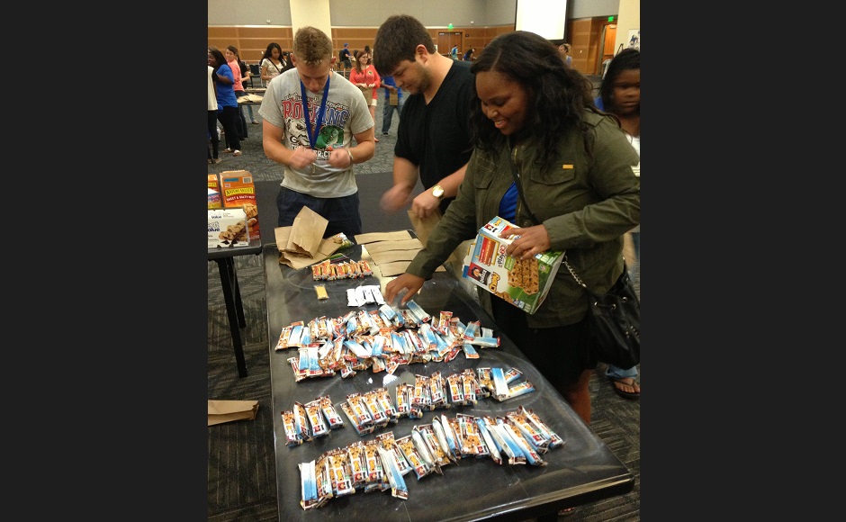 Students package snacks for children at ‘Freshman Day of Service’ event