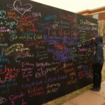 Eric Abernathy, a junior majoring in Mass Communication, writes on the chalk wall Feb.14, 2017.