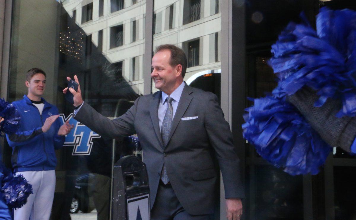 Head coach Kermit Davis waives to fans as his team departs from the hotel towards the arena to play Minnesota in Milwaukee, WI on March 16, 2017. (MTSU Sidelines/Tyler Lamb)