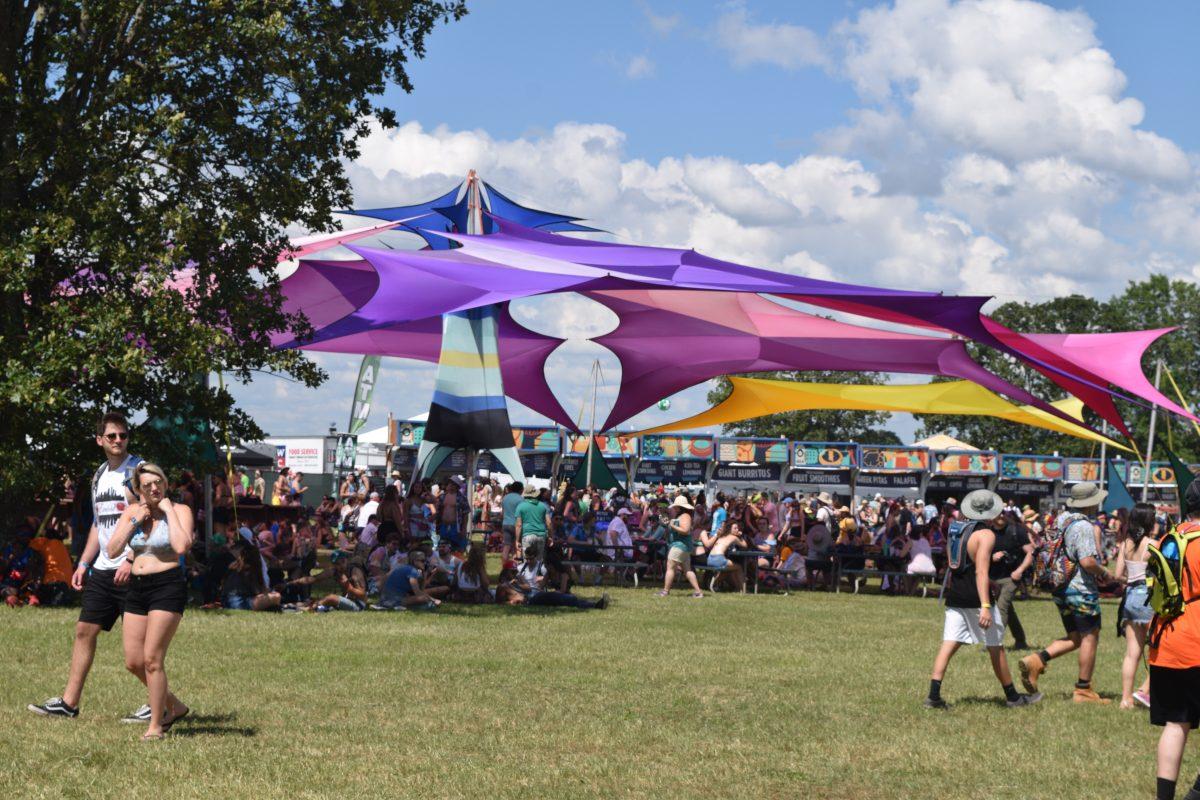 Bonnaroo attendees cool off under a rainbow tent in Centeroo on June 8, 2017. (Andrew Wigdor / MTSU Sidelines)