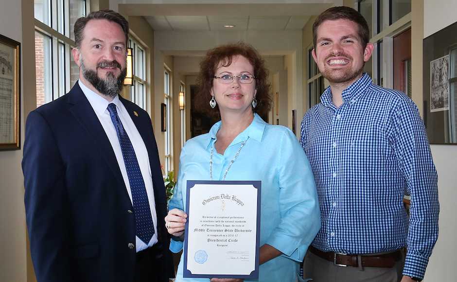 MTSU Honors College Associate Dean Philip Phillips, Honors events and Omicron Delta Kappa membership coordinator Susan Lyons and Matthew Hibdon, national headquarters liaison, are shown with the certificate indicating MTSU’s ODK status as 2016-17 Presidential Circle of Excellence recipient. (MTSU photo by Marsha Powers)