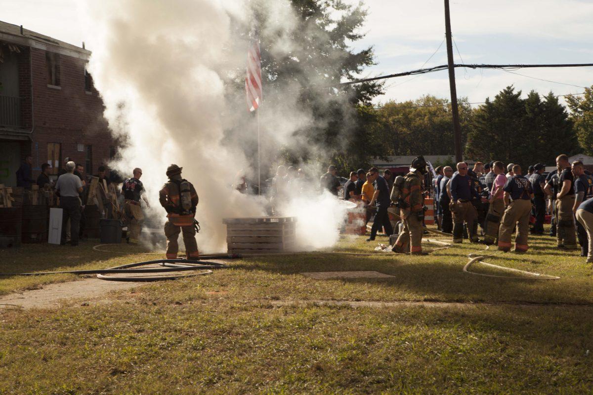 Instructors demonstrate how fire reacts and moves through a house with a dollhouse exercise on Oct. 17, 2017. (Sabrina Tyson / MTSU Sidelines)