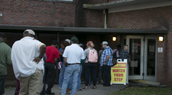 Students and Murfreesboro residents line up outside the voting polls.