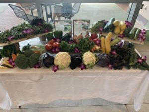 Fresh produce is lined up on a table for students to peruse at the Farmers Market dining hall.