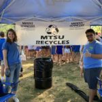 Regan Olivares and Pablo Avila, SEA representatives, stand happily in front of and MTSU recycles sign at Walnut Grove on Saturday, September 7, 2019