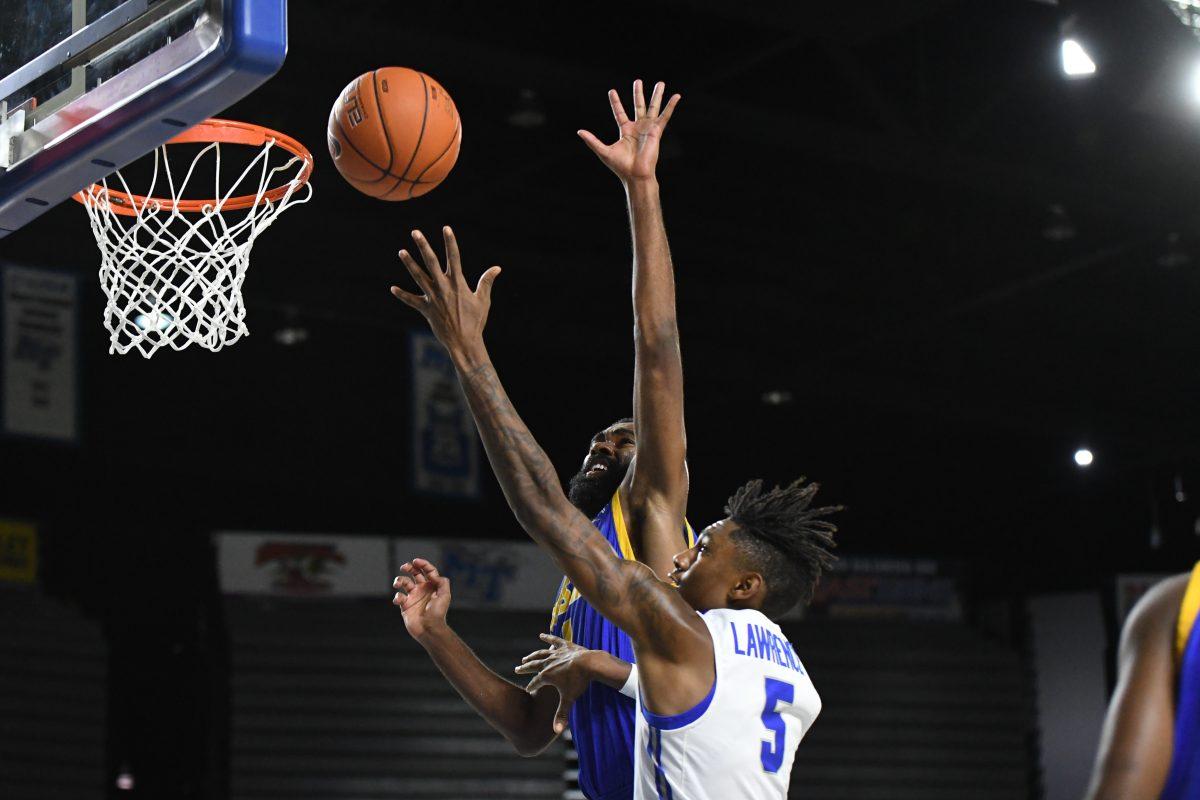 Eli Lawrence attempts a layup over a Mars Hill defender during the Blue Raiders victory on Wednesday night. (Photo by Kaitlyn Hungerford/ MTSU Sidelines)