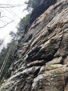 MTSU student Samantha War makes her way up a difficult rock face named “There’s no place like home.” The rock face is extremely sheer, and War is only about halfway up. Trees and roots dot the edges of the cliff, and the challenge is obvious.