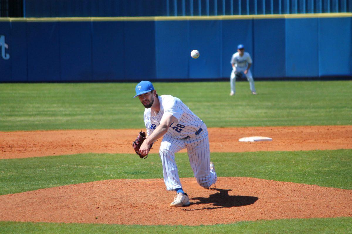 Peyton Wigginton pushes downhill to slip a breaking ball by the batter. (Will Carter / Sports Editor)