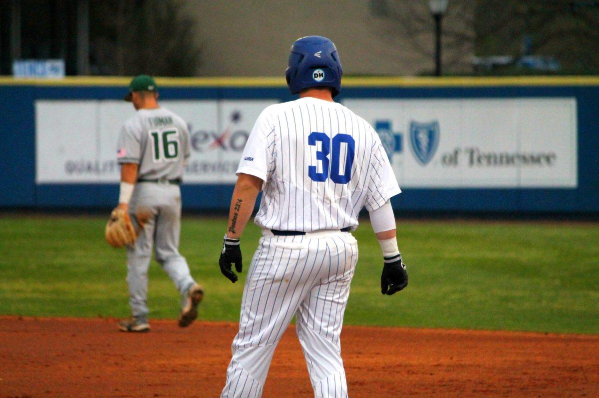 Wyatt Morgan stands on first base after one of his base hits against Charlotte. (Will Carter / Sports Editor)