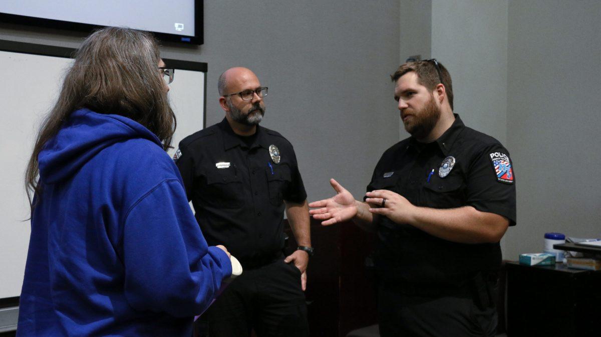 Sgt. Jason Hurley and Lt. Jacob Wagner chat with a concerned faculty member after the event. (Photo by Aubrey Salm) 