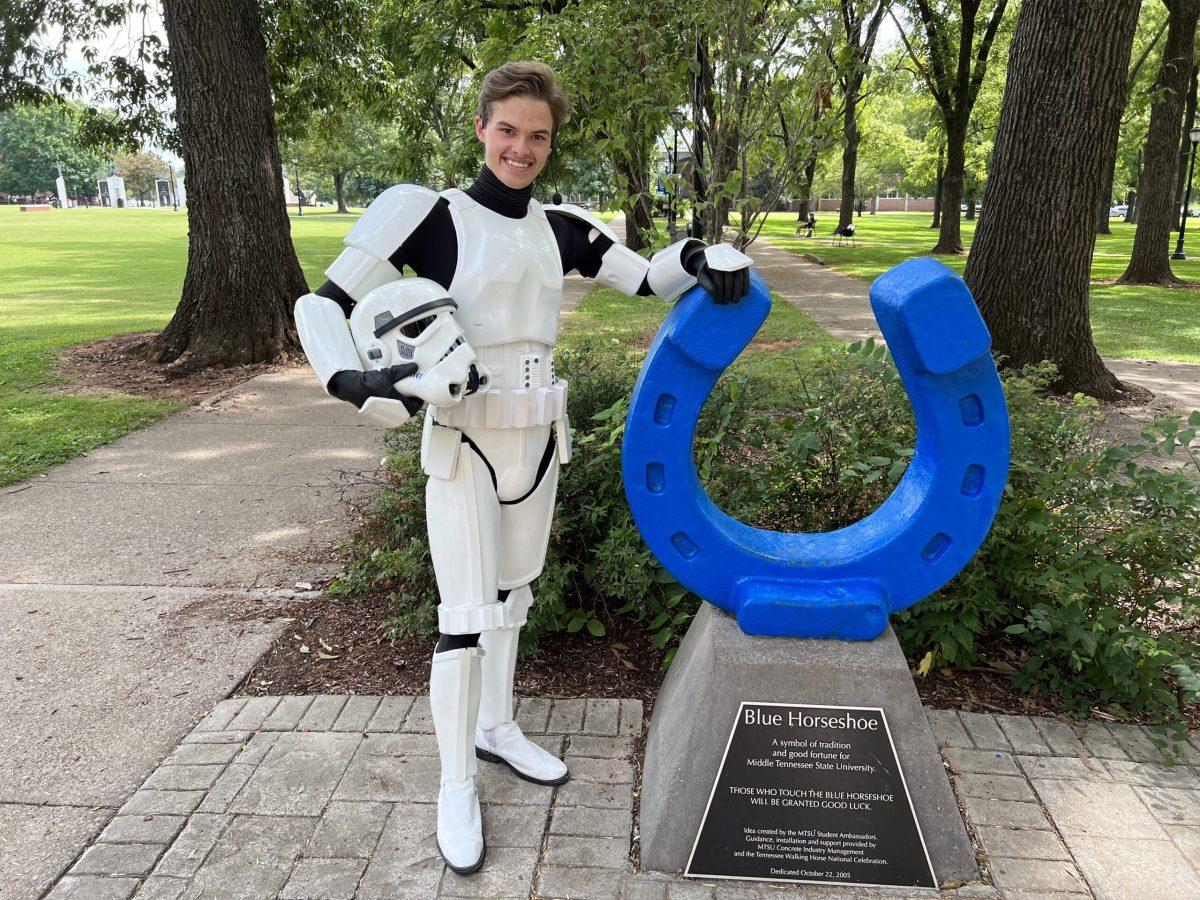 Christian Dunham, a junior MTSU student, leans on the Lucky Blue Horseshoe while wearing his 501st Legion Stormtrooper costume. (Photo by Matthew Giffin)