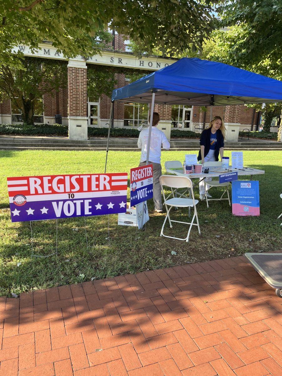 Members of the American Democracy Project setting up tents and tables to kick off National Voter Registration Month in September. (Photo by Kayla Walker)