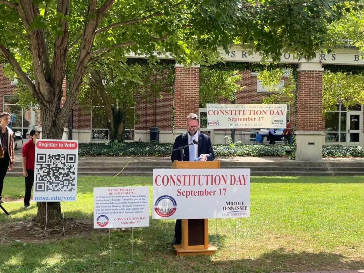 Associate Dean of the Honors College Philip Philips reads a portion of the U.S. Constitution in front of the Honors College building. (Photo by Lillian Chapman)