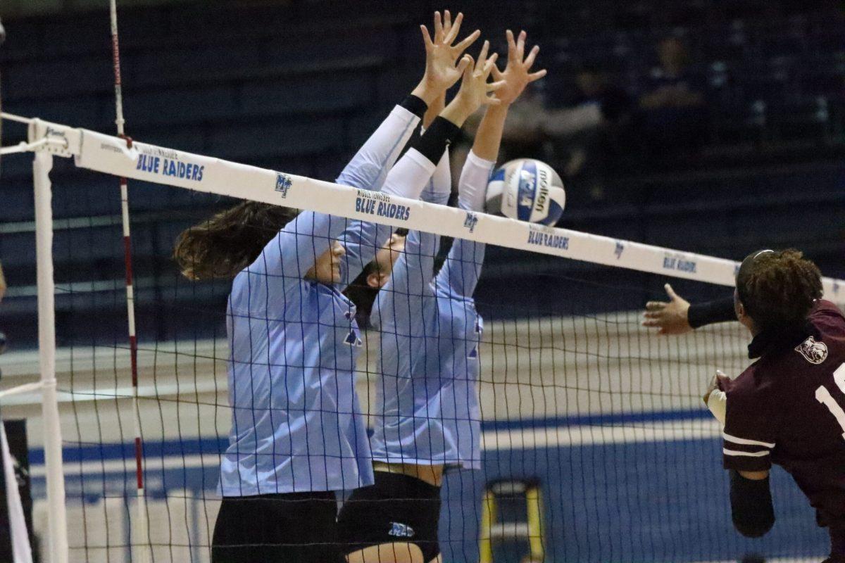 The Lady Raiders jump to block the ball. Photo by Lucas Larkin. 