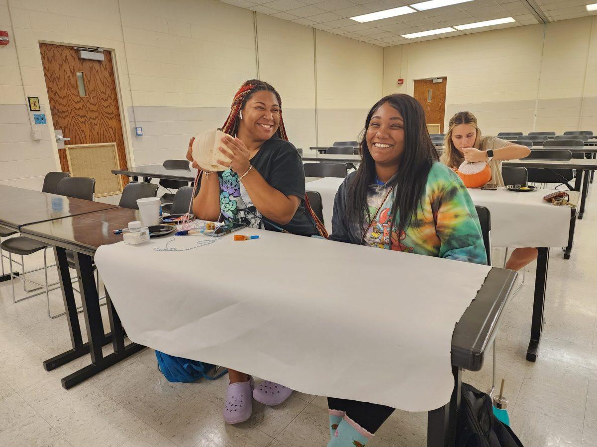 Serlita Rangel (right) and her friend getting ready to paint. Photo by Jordan Reining.