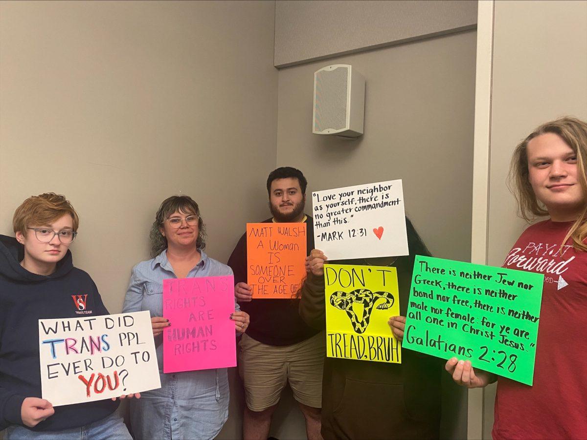 From left to right, Eli Certain, Davina Miller-Clements, Ravel Pirouznia Jr., Katrina Aguilar and Ty Stallings pose with the signs they made for the protest. (Photo by Alyssa Williams)