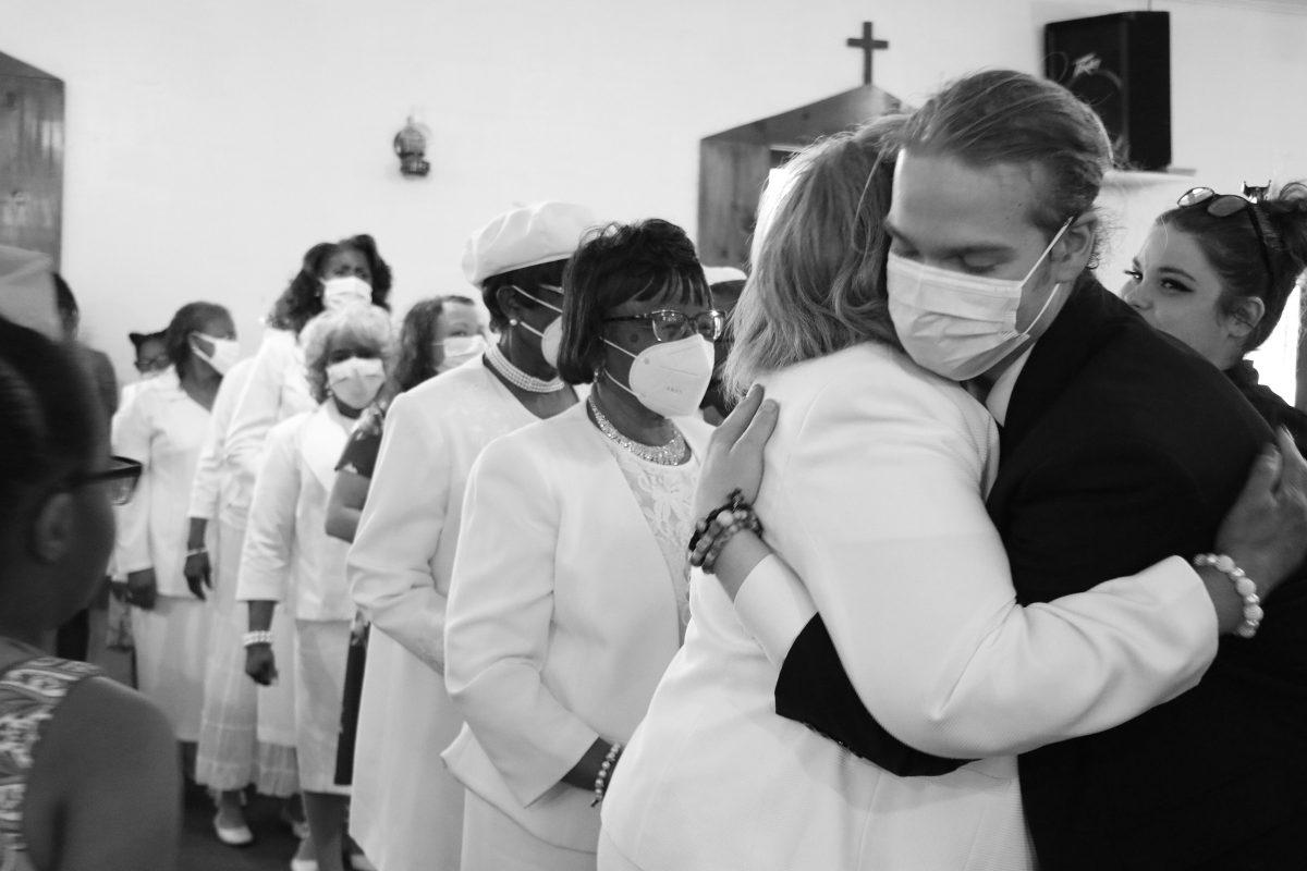 The Church Mothers and Usher Board line up to greet the newest member of Beans Creek after a baptism. Photo by Kailee Shores.