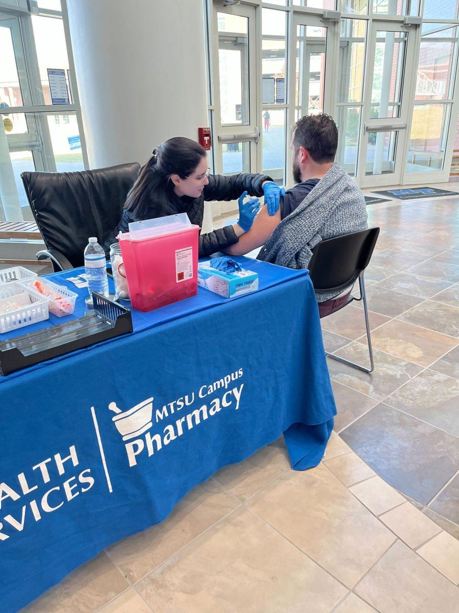 An additional free Flu shot clinic was held in the lobby of the Campus Recreation Atrium where Stephanie Cal, a Lipscomb Pharmacy Intern administers a flu shot into Dj Steffensen’s arm, a faculty member in the Department of Management. (Photo by Kayla Walker)