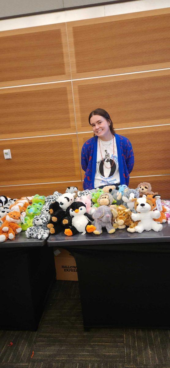 Claire Holbrook, SPARE Promotions Manager, displaying stuffed-animal goodies. (Photo by Sydney Schettler).