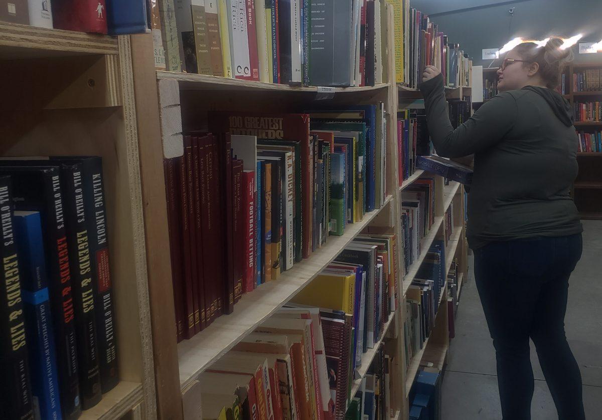 Local student looks at the bookshelves.