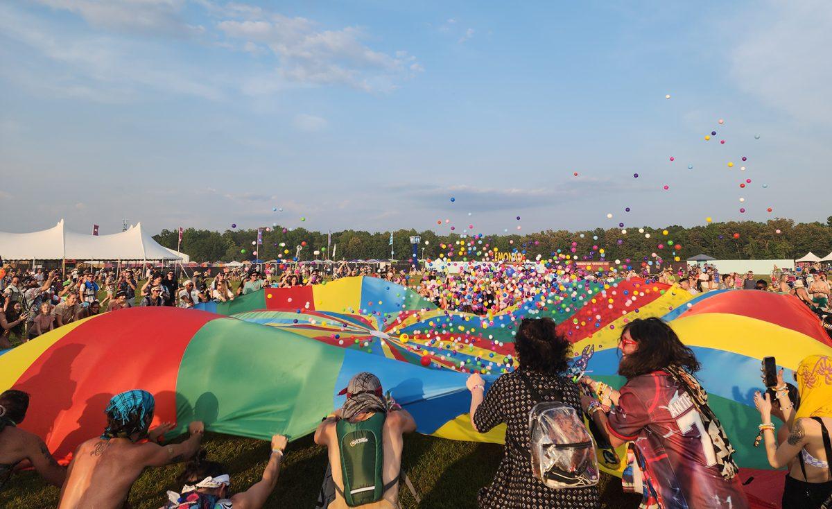 Bonnaroovians take part in waving the parachute, sending a rainbow of plastic balls soaring through the air. (Taken by Brian Branch)