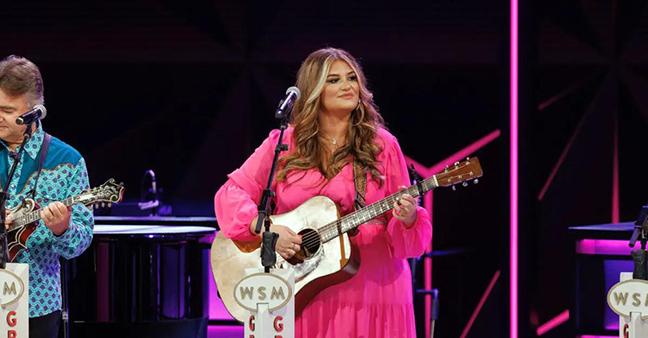 Her pink dress shimmering in the spotlight on the stage of the Grand Ole Opry, MTSU alumna Jaelee Roberts performs a solo set at the iconic venue on September 19. She graduated with a commercial songwriting degree in August. (Photo courtesy of Jaelee Roberts)