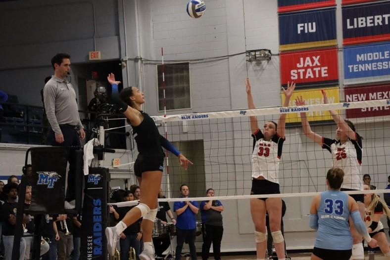 Adri Rhoda jumps to spike the ball. (Photo by Savion Davis)