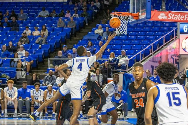 Justin Bufford scoops in a layup. (Photo by Khori Williams)