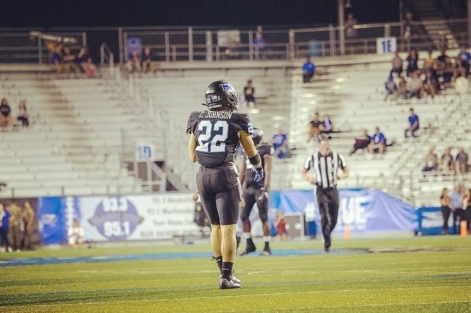 C.J Johnson lines up on the football field. (Photo by Khori Williams)