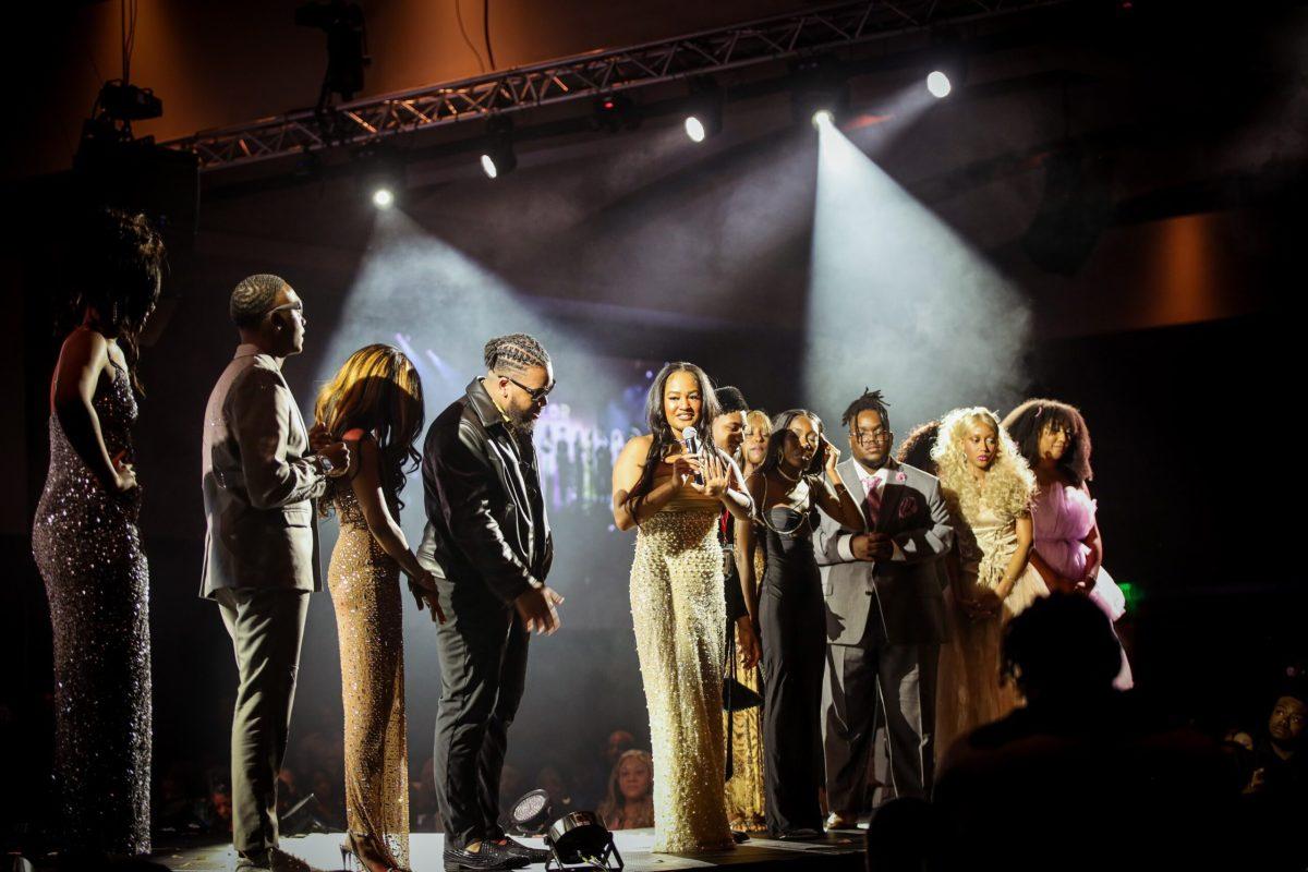 Director Ani Woodard gives her speech with the runway team beside her at the end of Color the Runway 2024.