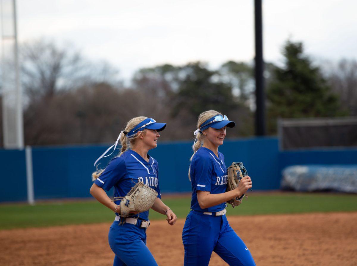 Shelby Sargent and Lexi Medlock jog off the field. (Photo by Preston Todd) 