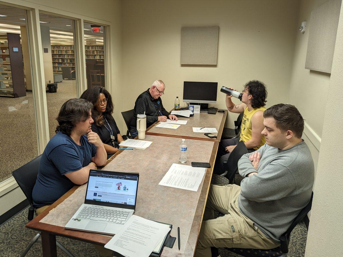 Leaders from the United Campus Workers draft their speech in the Walker Library on Friday, which they will deliver to the Board of Trustees on Tuesday.