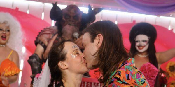 Keisha (left) and Austin Bourgeois (right) seal their marriage with a kiss in front of Blothar the Berserker from GWAR at The Bonnaroo Music & Arts Festival at Manchester, Tennessee. (Taken by Skyler Wendell)