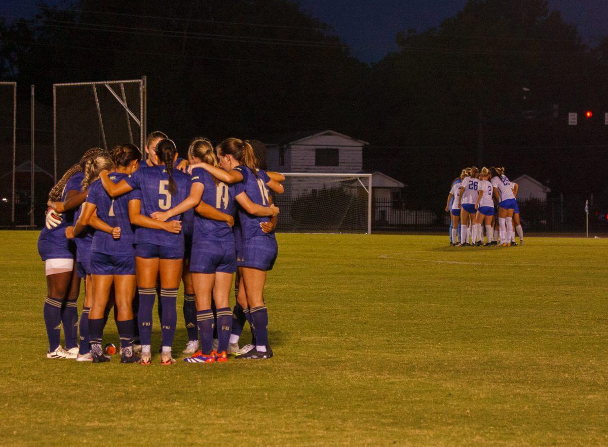 Team huddles during MTSU v FIU, 9-19-2024. (Photo by Paige Mast)