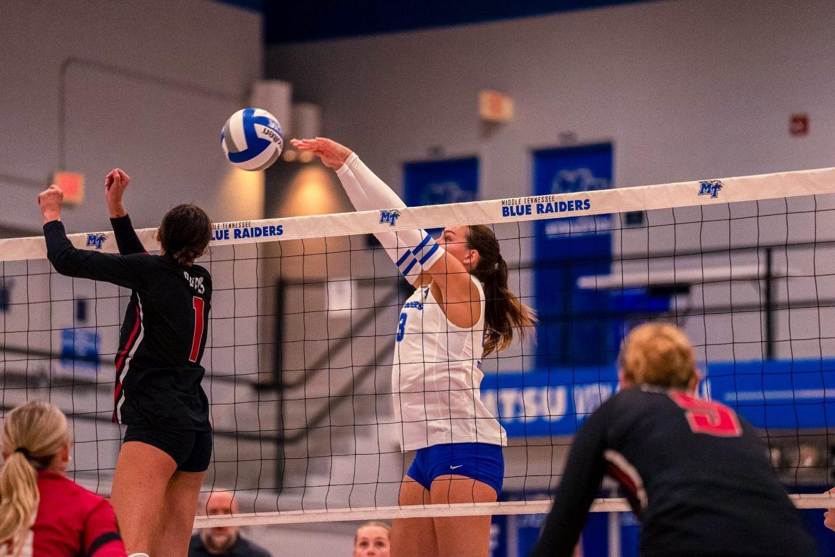 Kiera Booth slams the ball at the net against Arkansas State, 9-7-2024. (Photo by Rusty Miller)