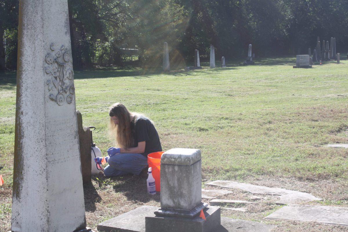 Student James Long works patiently at Old City Cemetery in Murfreesboro, Tennessee, on Oct. 11, 2024. (Photo by Shauna Reynolds)