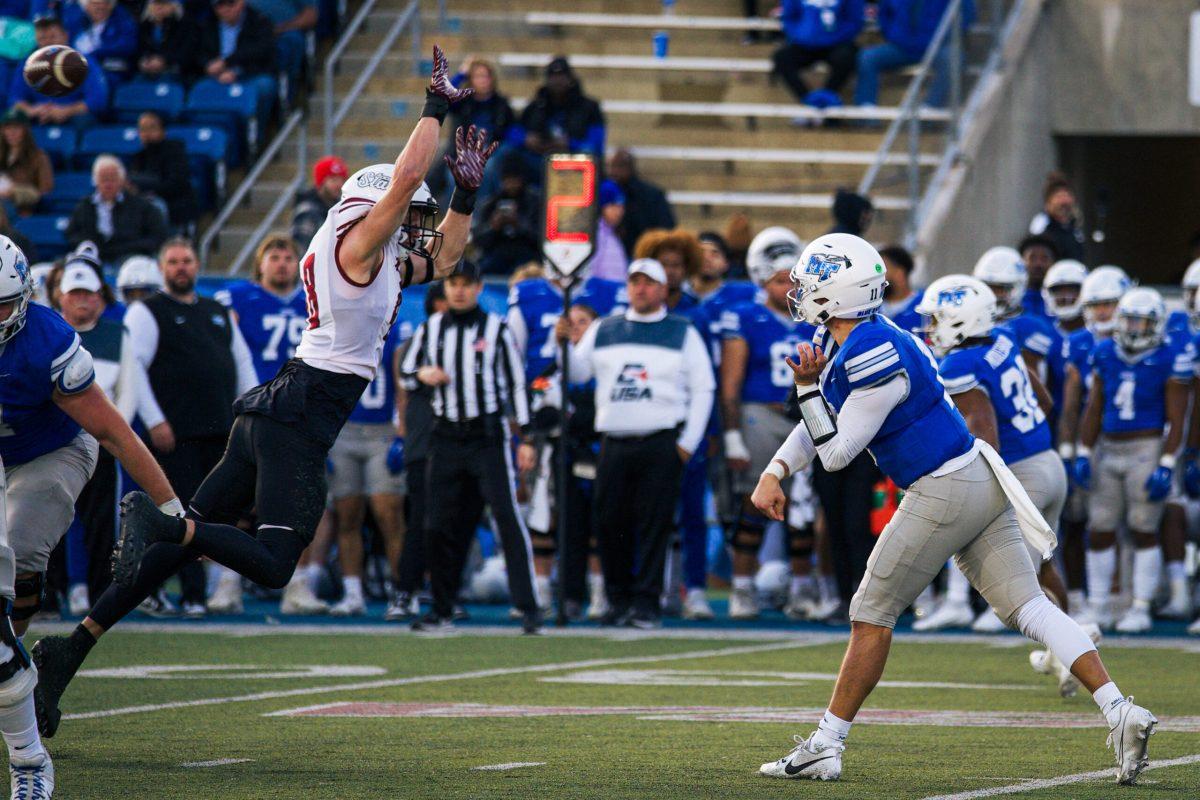 Nick Vattiato fires a pass over a leaping Aggie defender, 11-23-2024. (Photo by Rusty Miller)