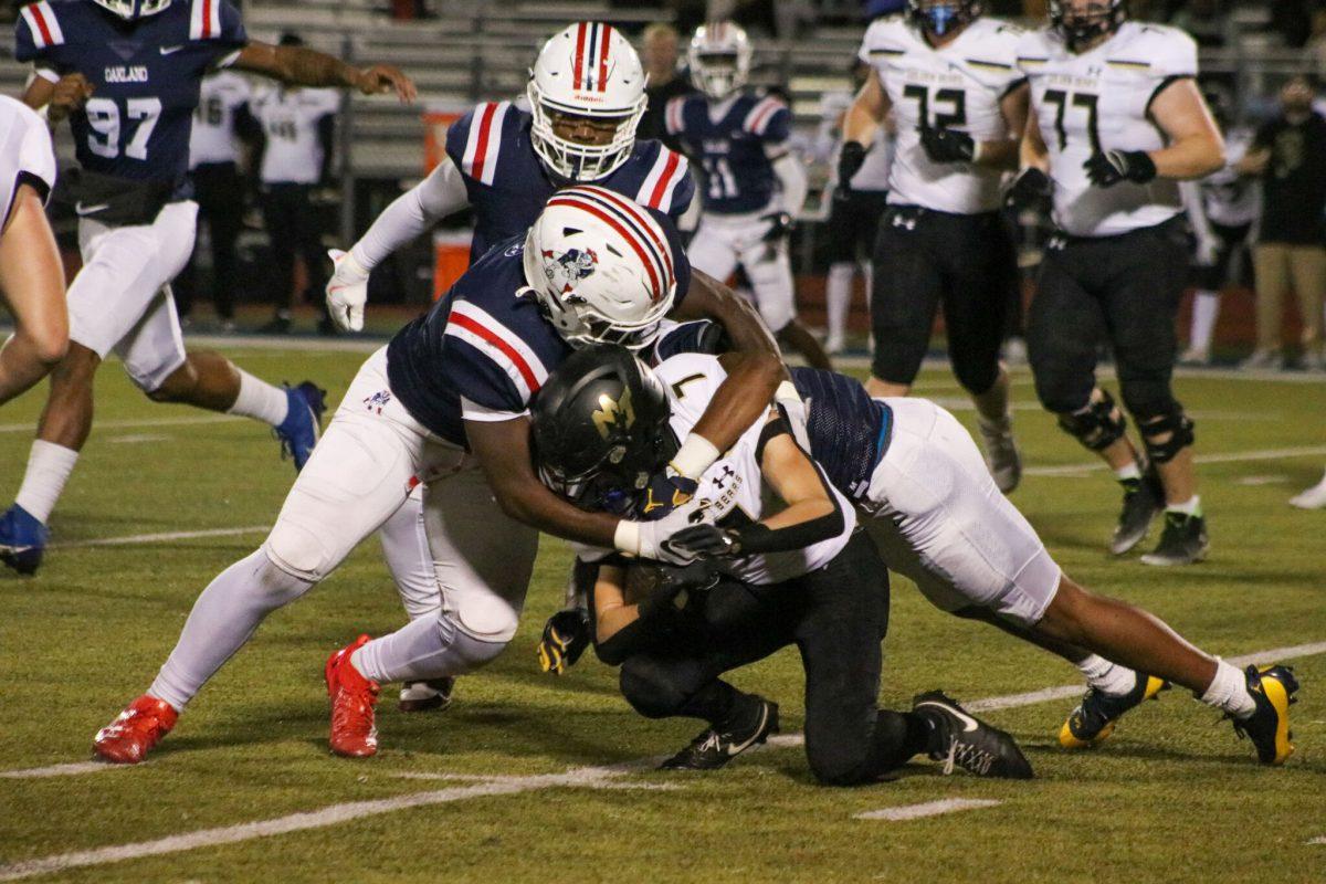 A troop of Patriots rally to tackle a Mt. Juliet Golden Bear, 11-15-2024. (Photo by Ephraim Rodenbach)