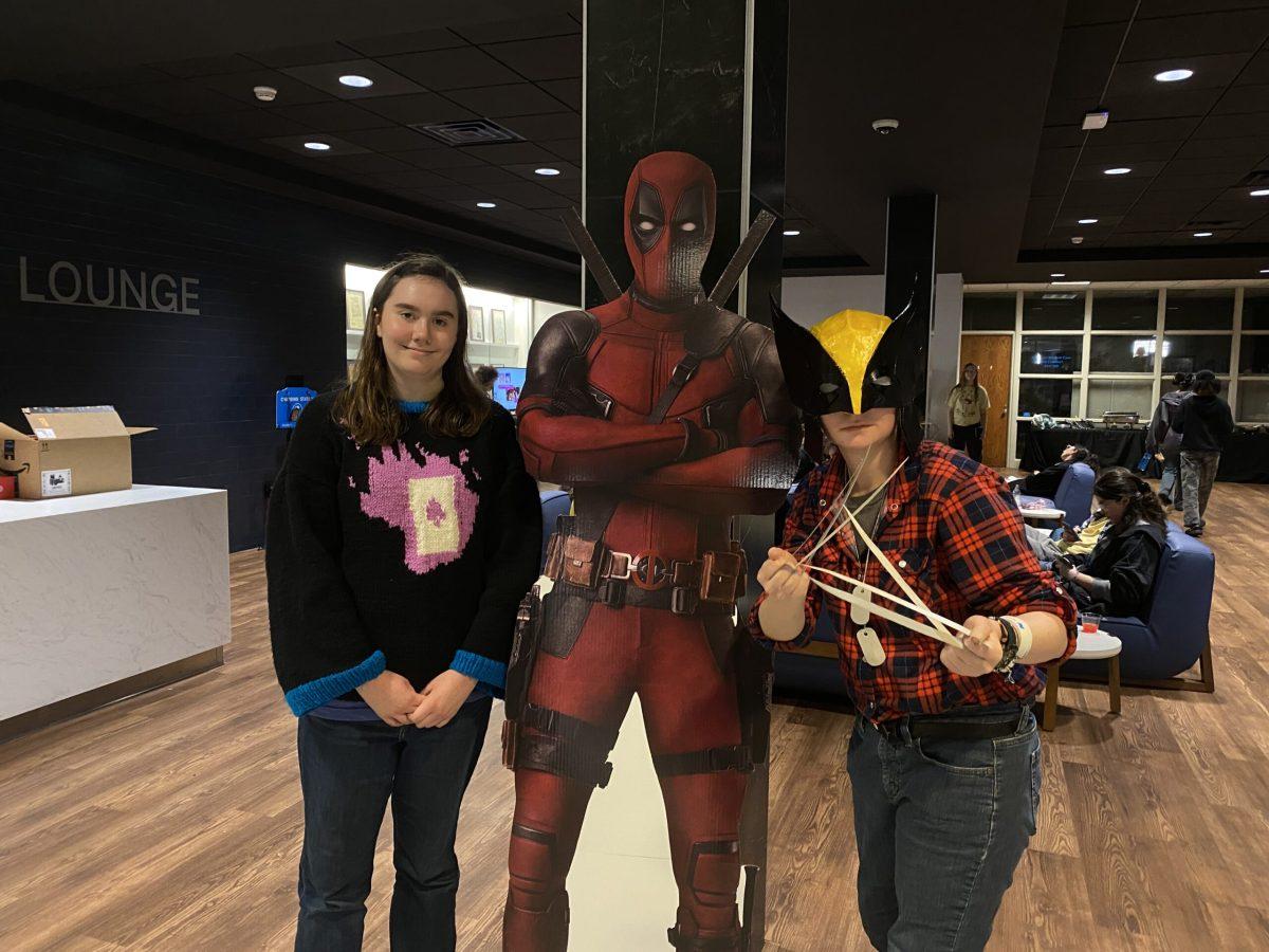 Brooke Ryan (left) and Leslie Ryan (right) show off their handmade "Deadpool and Wolverine" outfits next to Deadpool himself. (Photo by Bailey Brantingham)