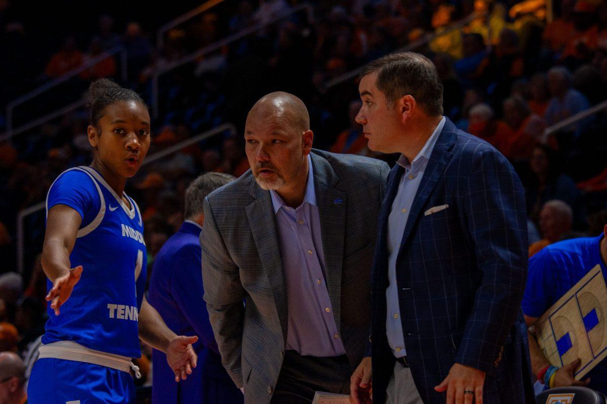 Courtney Blakely talks with associate head coach Matt Insell and assistant coach Tom Hodges during a time out, 11-12-2024.