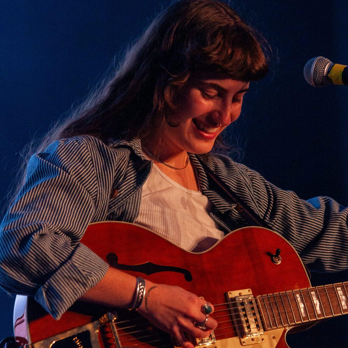 Cece Coakley smiles down at her guitar in Murfreesboro, Tennessee, on Nov. 13, 2024. 