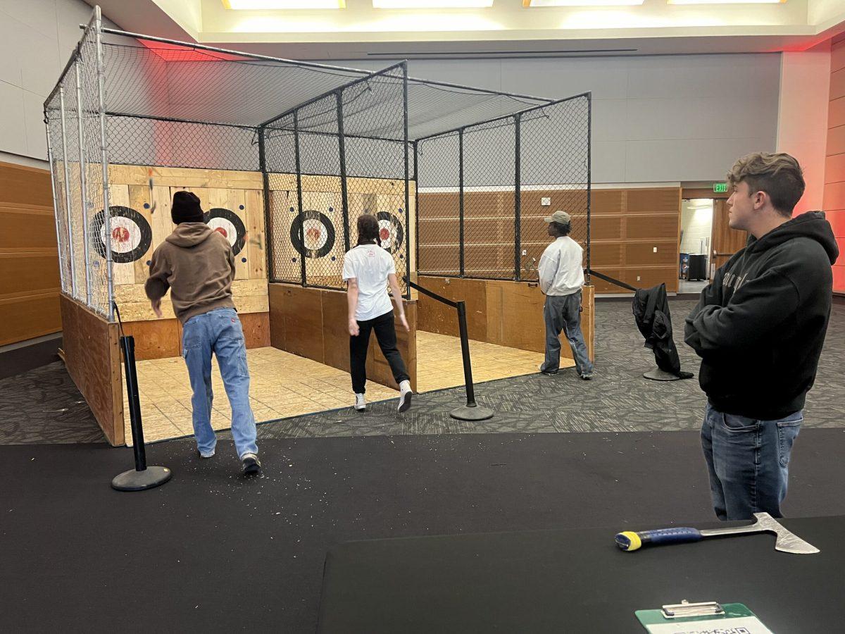 Students fling axes at MTSU's Rage and Relax on Dec. 2, 2024. (Photo by Victoria Stone)