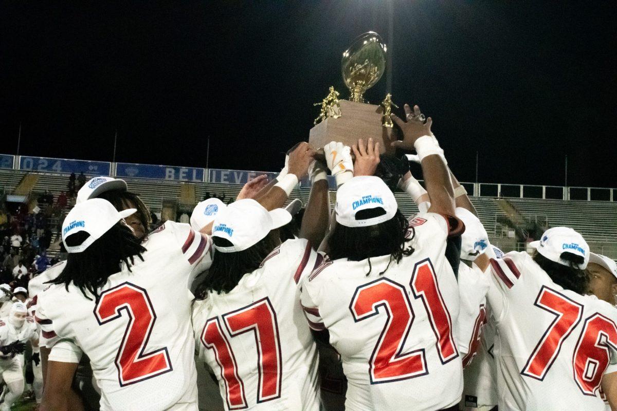 Oakland hoists its eighth state championship trophy after defeating Houston, 12-7-2024. (Photo by Erin Douglas)