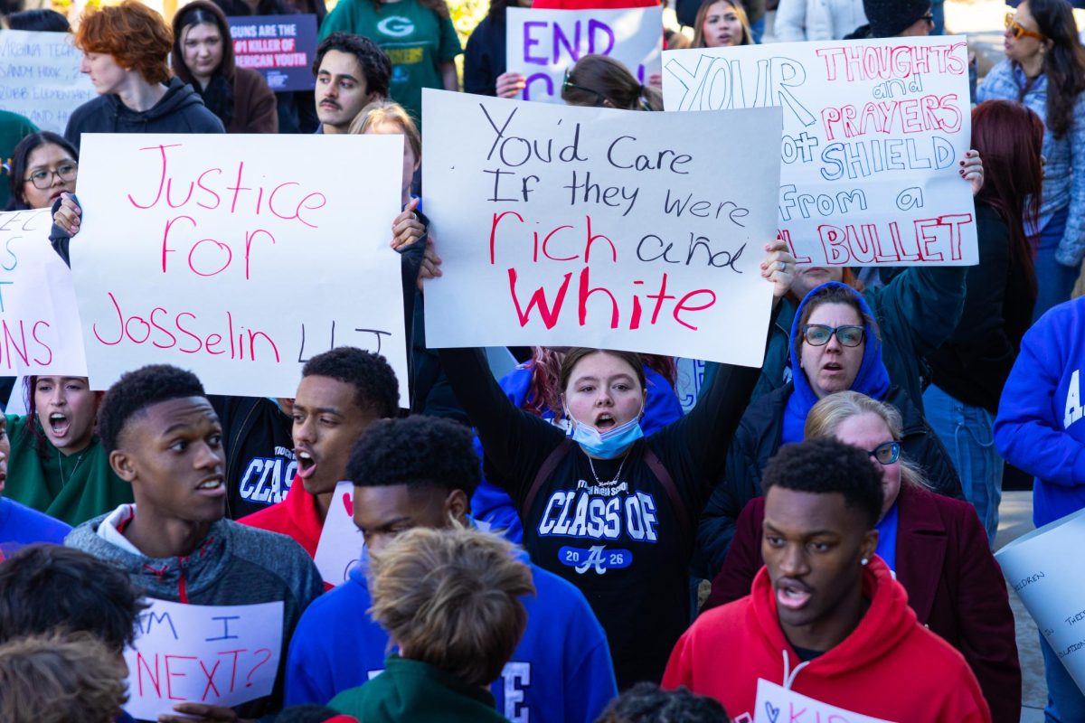 Protester yells as she holds a sign in Nashville, Tennessee, on Jan. 27, 2025.