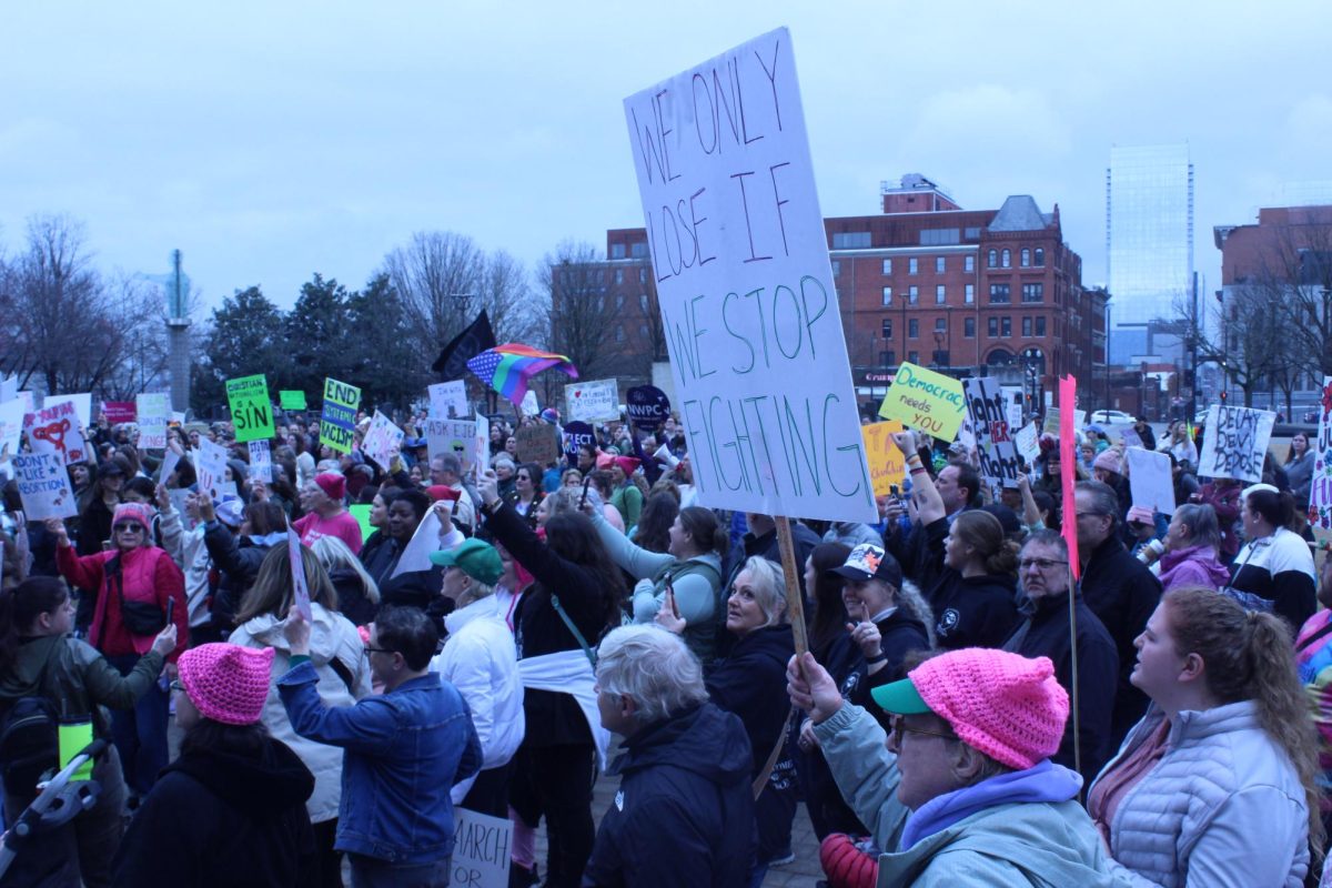 The crowd of protestors at Public Square Park with one man holding a sign reading, “We only lose if we stop fighting,” in Nashville, Tennessee, on Jan. 18, 2025.