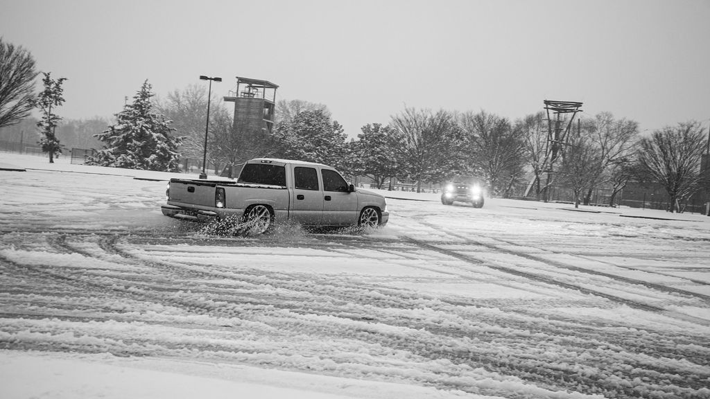 Trucks do donuts in a snowy MTSU parking lot in Murfreesboro, Tennessee, on Jan. 10, 2025.