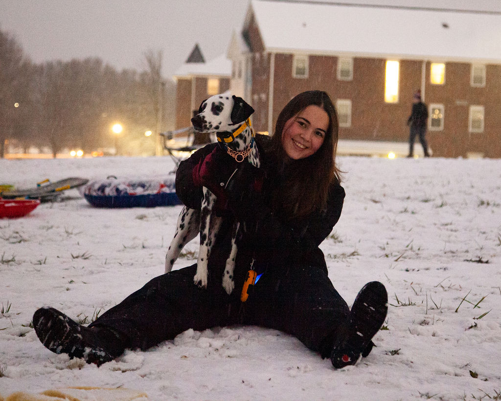 A student enjoys the snow with her canine companion in Murfreesboro, Tennessee, on Jan. 10, 2025.