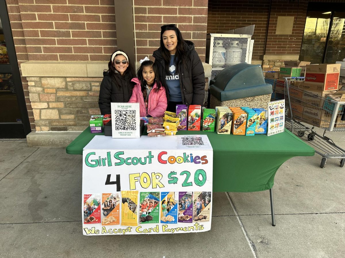 Girl Scouts Sofia Douangphanya  and Hannah Rivera sell cookies while leader Lucy Sique supervises in Murfreesboro, Tennessee, on Feb. 13, 2025.